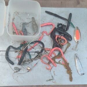 Assorted Fishing Lures in Black, Pink, and Silver